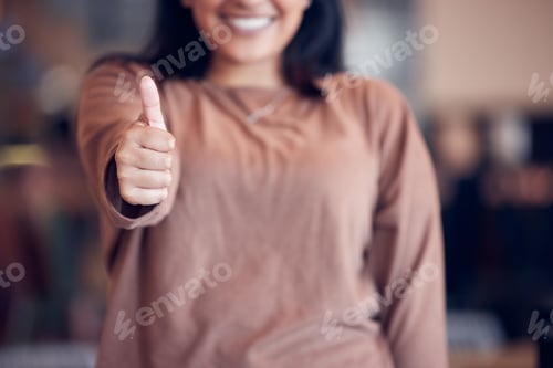 Preview: Happy to be here and healthy. Shot of a business owner giving the thumbs up in her business.