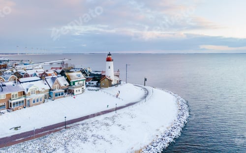 Preview: Lighthouse of Urk during winter with snow in the Netherlands. Dutch old village