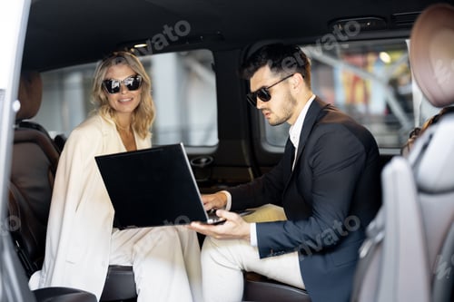Preview: Business people sitting in minivan taxi