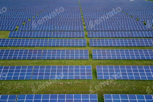 Preview: Aerial view of big sustainable electric power plant with many rows of solar photovoltaic panels