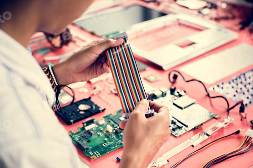 Preview: Technician holding flexible flat cable at workshop