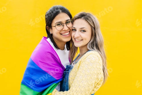 Preview: Portrait of lovely young lesbian couple hugging each other smiling at camera