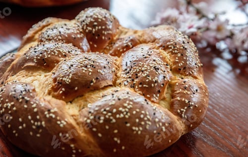 Preview: Easter sweet bread, greek tsoureki, brioche braid on wooden table, close up overhead