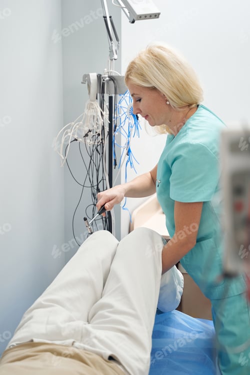 Preview: Woman in medical uniform examining male patient