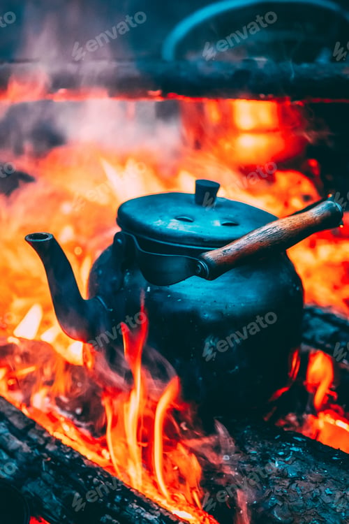 Preview: Old Retro Iron Camp Kettle Boiling Water On A Fire In Forest. Br