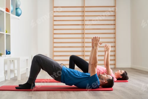 Preview: a young man and a young woman doing gymnastics for toning up