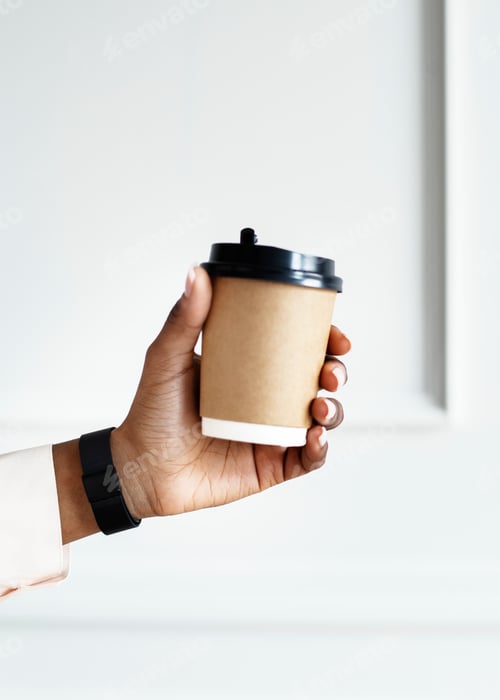Hand Holding a Coffee Cup in White Setting