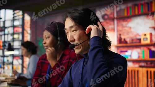 Preview: Call center employee gesturing loud coworker to lower down voice