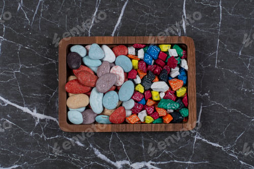 Preview: Different kinds of chocolates on the board , on the marble background