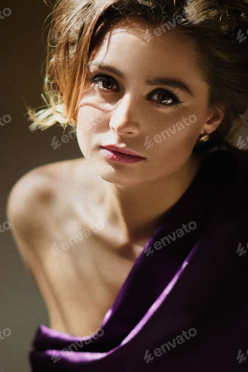 Preview: model girl in a blue dress in an art workshop with brushes