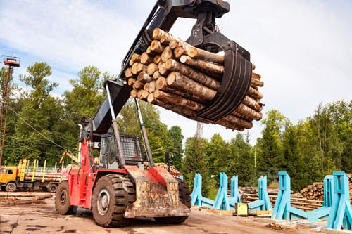Preview: Harvester log loader working in plant manufacturing yard outdoors. Sawmill