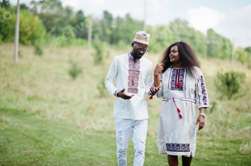 Preview: African couple in traditional clothes at park.