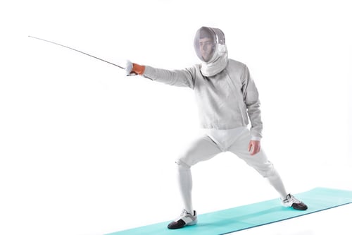 Preview: side view of fencer in uniform training with rapier in hand isolated on white