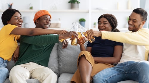 Preview: Group of black friends enjoying drinks party at home