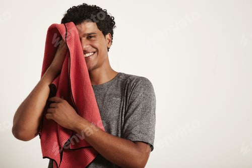 Preview: Young black sportsman wiping his face with a towel