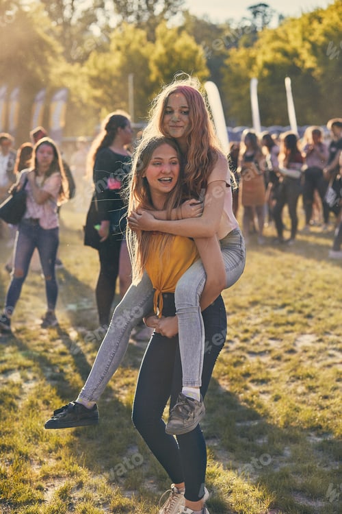 Preview: Portrait of happy smiling young girls with colorful paints on faces and clothes