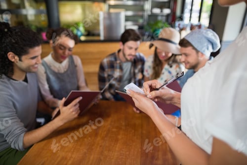 Preview: Waitress taking orders of customers in restaurant