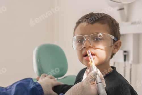 Preview: Close-up shot of a dentist repairing a boy child's tooth in a dental clinic