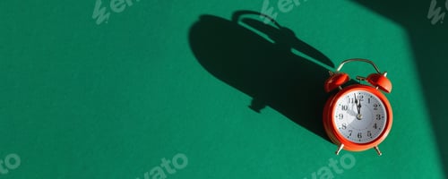Preview: Red alarm clock with overlay shadow isolated on green background. Christmas New Year greeting card