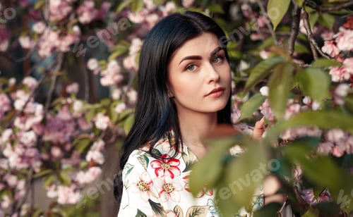 Preview: Elegant female near blooming tree in garden
