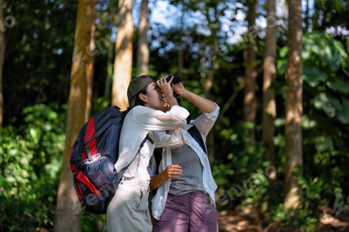 Preview: Backpack tourist travel outdoor adventure bird study using binoculars looking and record to book