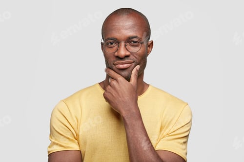 Preview: Studio shot of confident pleased African American male boss thinks about new investment plan, holds