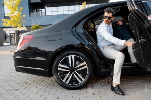 Preview: Businessman gets out of a premium car