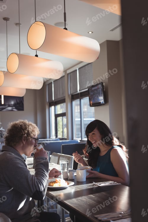 Preview: Couple having breakfast in the kitchen