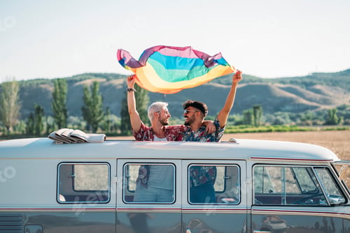 Preview: Gay couple in van holding LGBT flag