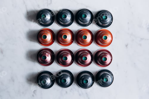 Preview: Top view of colorful coffee capsules arranged in four rows
