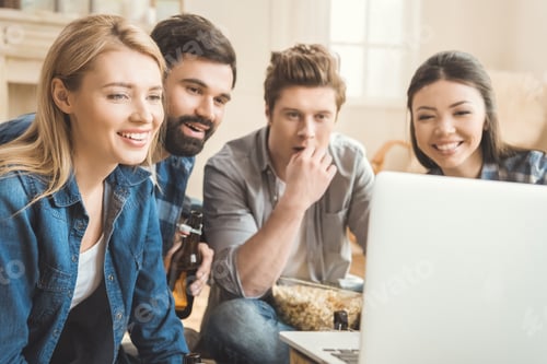 Preview: Two young couples watching movie on laptop while drinking beer and eating popcorn