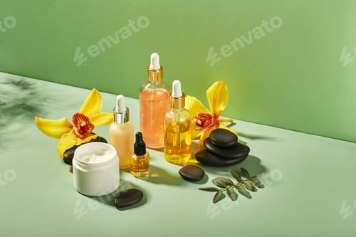 Preview: Cosmetic care products in glass bottles with orchid flowers - serums, cream, gel, oils. Concept for