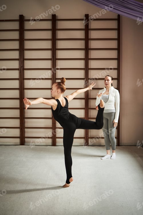 Preview: Teenage Caucasian Girl Practicing Ballet Pose While Female Instructor Observing