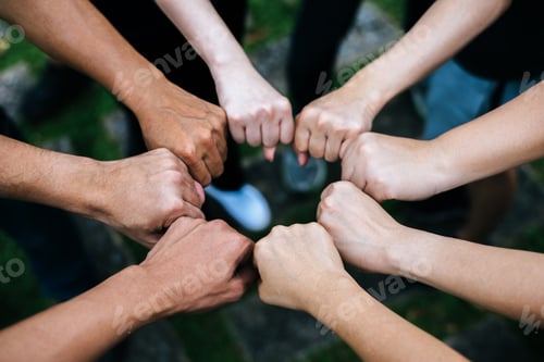 Preview: Close up of students standing hands making fist bump gesture.