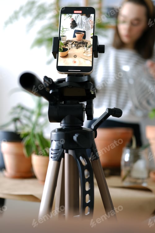 Preview: Young beautiful woman blogger making a video for her blog using phone camera at home.