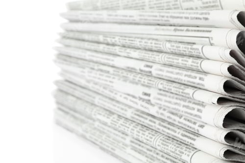 Preview: Stack of newspapers on white background, closeup. Journalist's work