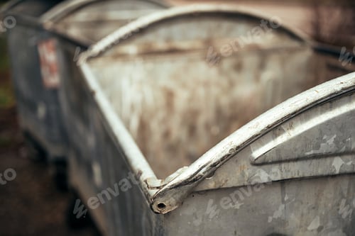 Preview: Worn old metallic garbage dumpster container or dust bins at the street