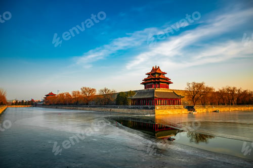 Preview: Asian castle silhouetted against a sunset over water in Beijing, China