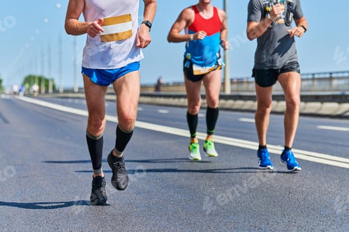Preview: Marathon runners on city road.