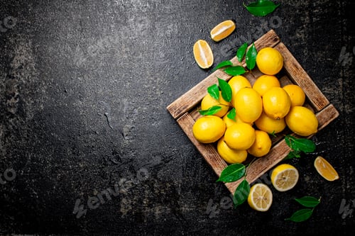 Preview: Lemons with leaves on a wooden tray.