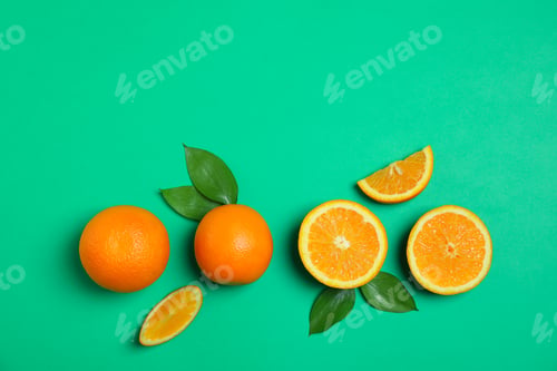 Preview: Flat lay composition with oranges and leaves on color background. Space for text