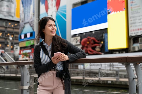 Preview: lady admiring the beauty of doutonbori river