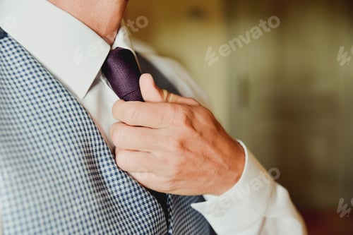 Preview: Executive man adjusting his neck tie for an important business meeting with lawyers.