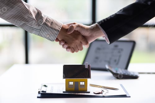 Preview: Businessman shaking hands with real estate agent in office after reaching home purchase agreement.
