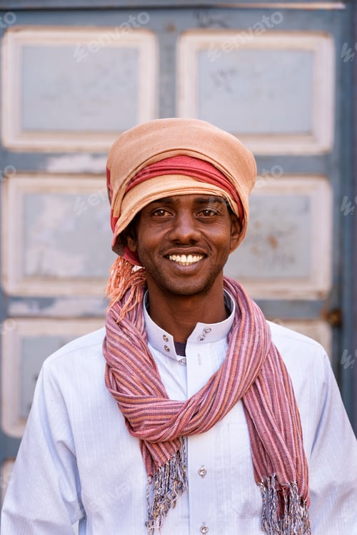 Preview: Optimistic Arab man in turban on sunny day in city