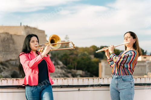 Preview: Flute and trombone duo rehearsing happily
