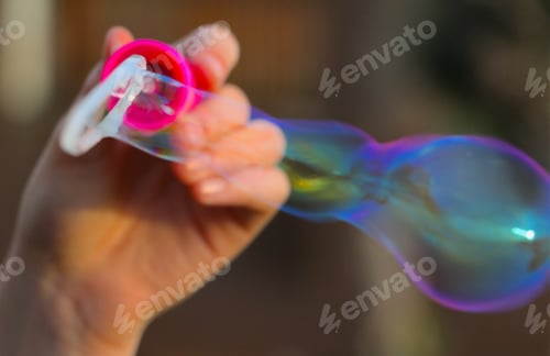 Preview: Closeup image of a beautiful bubble being blown from a bubble wand.