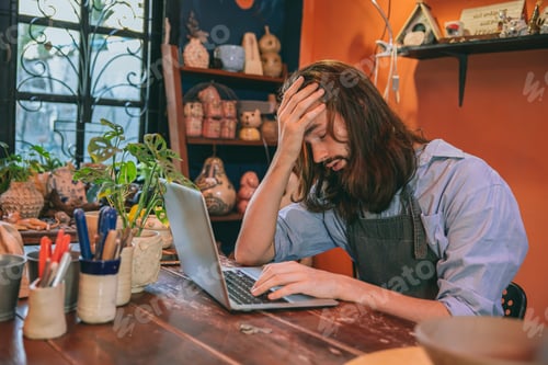 Preview: artist working at home studio no customer contact business fail down. man headache tired exhausted.