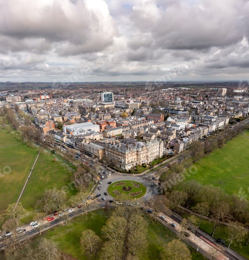 Preview: Aerial townscape view of Harrogate with traffic and The Stray public park