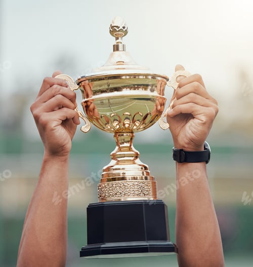 Preview: Closeup of unknown indian tennis player holding trophy and celebrating success after winning court